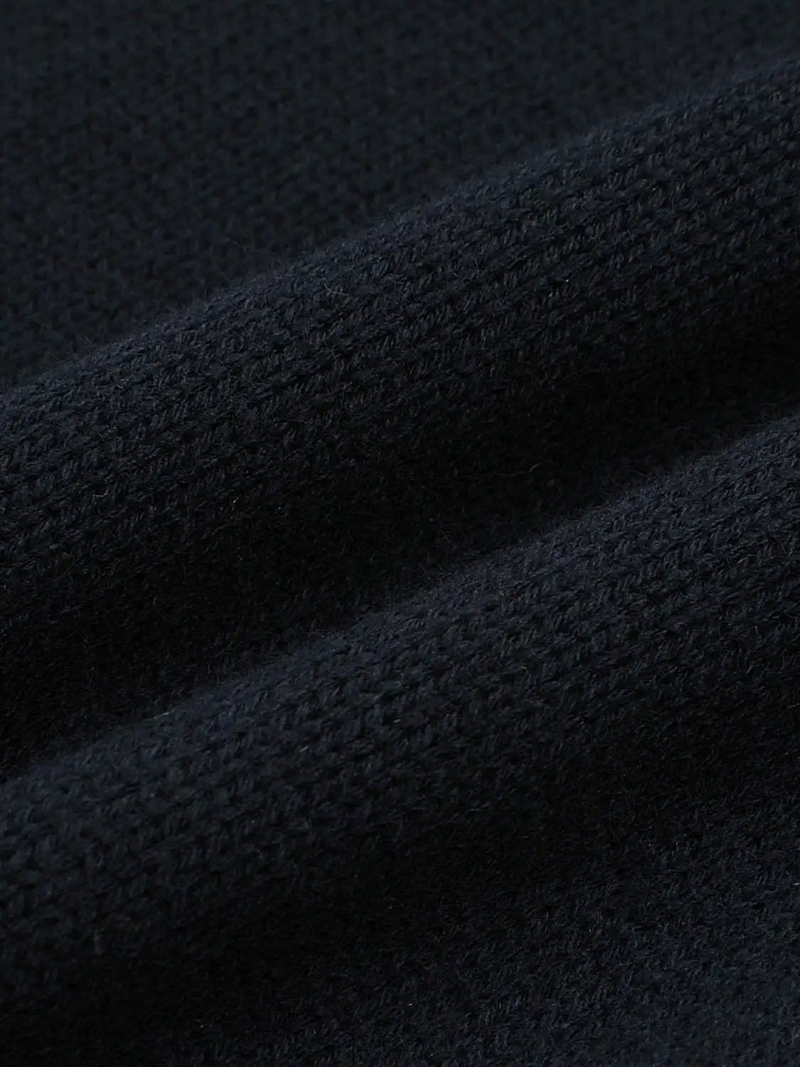 Graphic long sleeve ribbed knit cardigan fabric close-up in dark navy