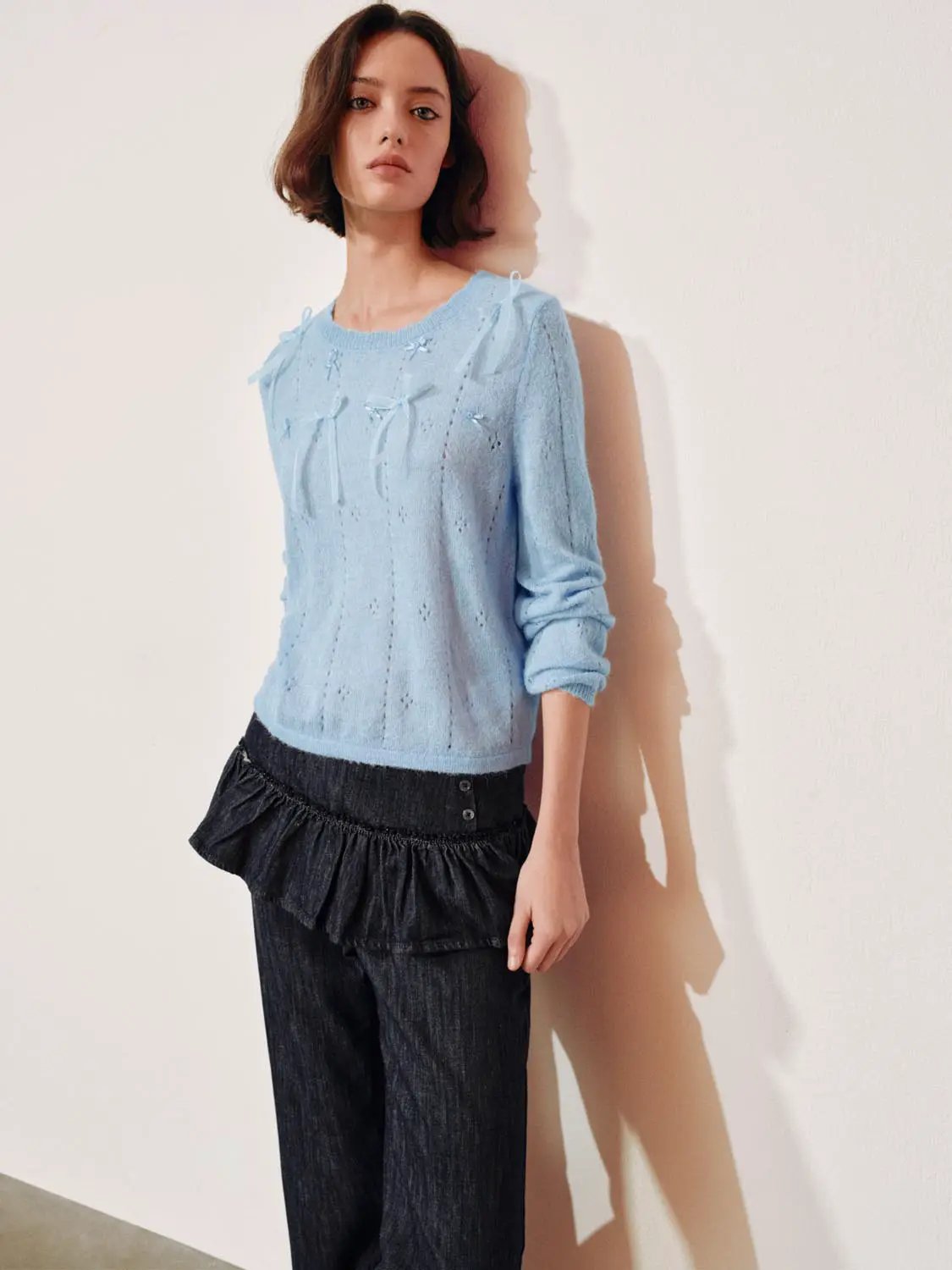 Bow-detail textured crew-neck long-sleeve sweater in light blue with bow accents.