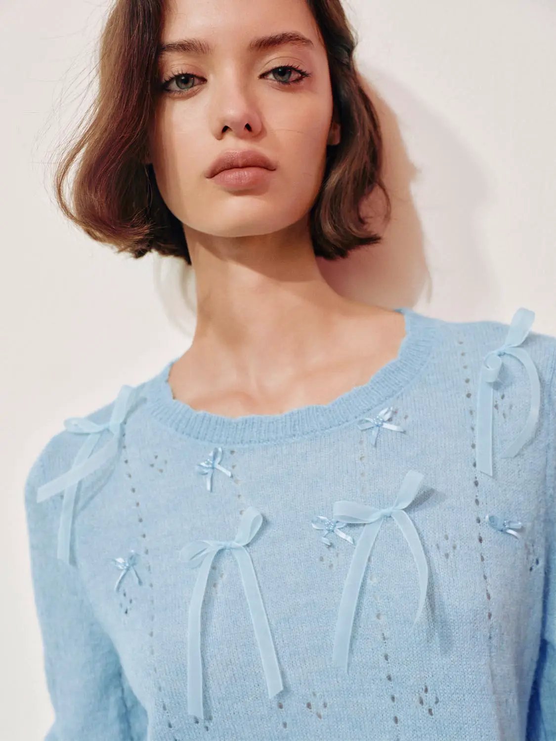 Bow-detail textured crew-neck long-sleeve sweater in light blue with ribbon bows.