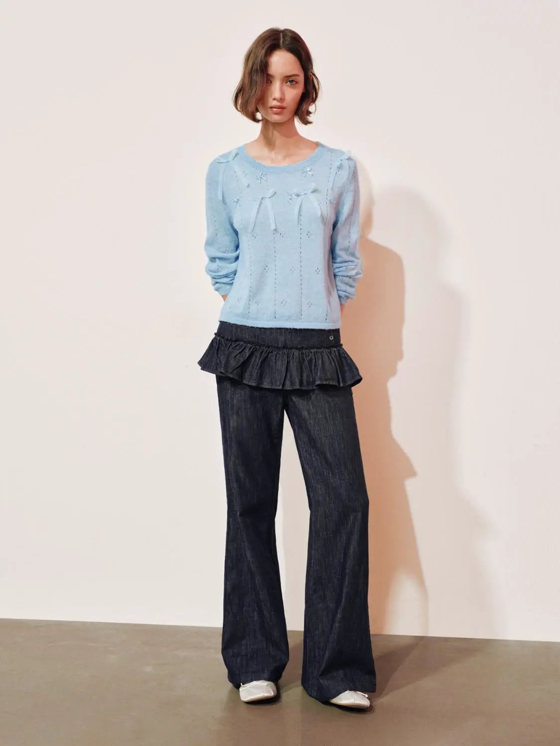 Bow-detail textured light-blue crew-neck long-sleeve knit sweater.