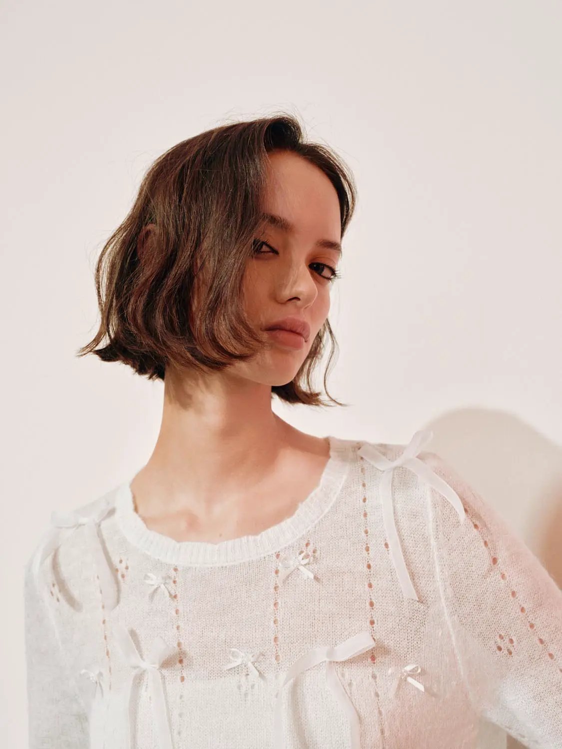 Bow-detail textured knit crew-neck sweater, white with ribbon bows.