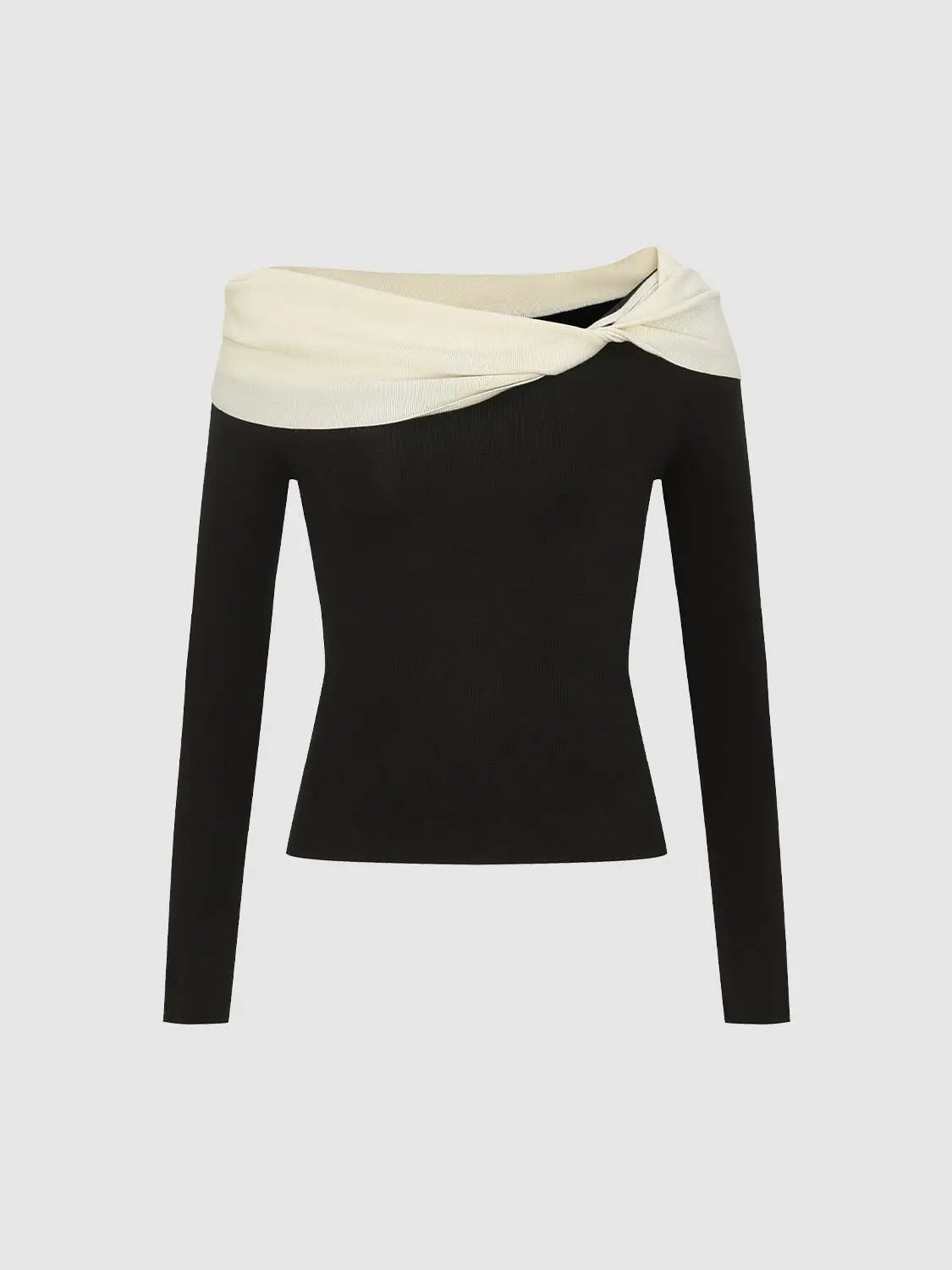 Knitted black long-sleeve top with cream twisted neckline.