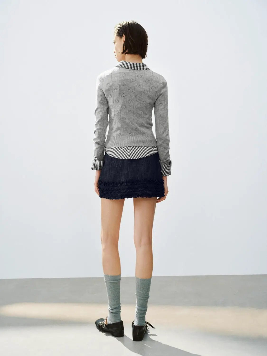 Textured grey knit long-sleeve sweater by Urban Revivo Fashion; back view with a check shirt peeking at the hem.