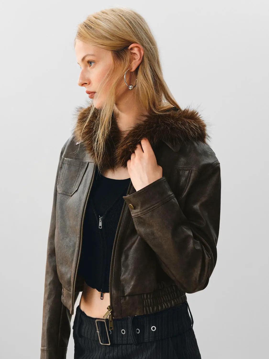 Leather jacket with a brown fur collar; zip front and dark brown finish.