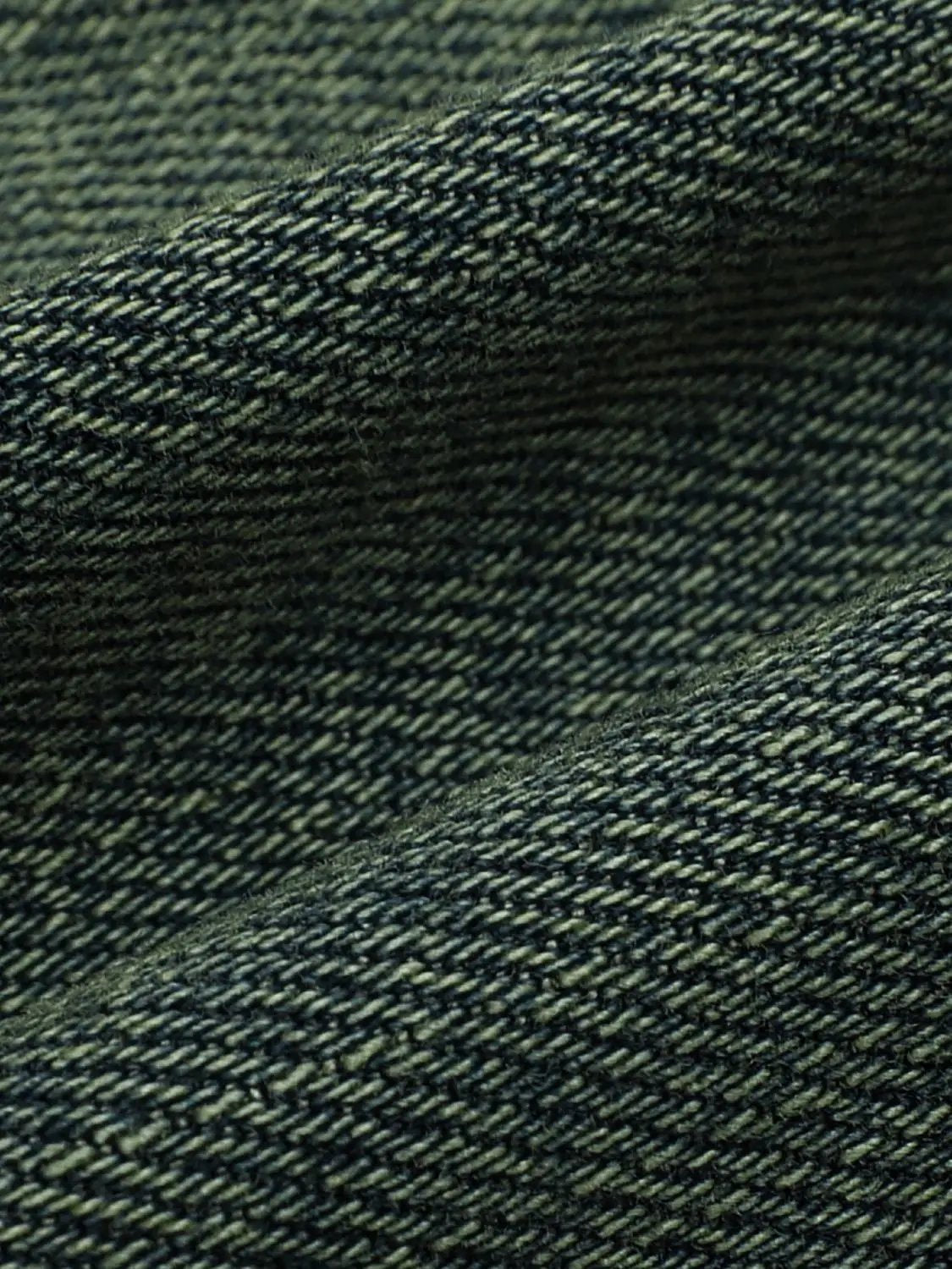 Denim shorts fabric close-up in dark indigo with twill weave