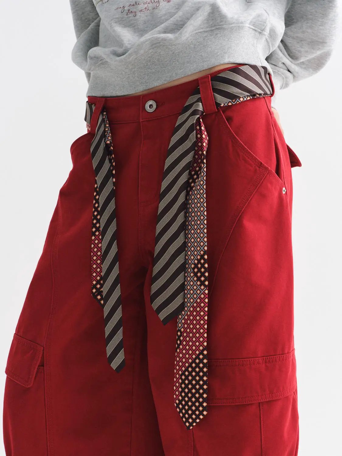 Casual red pants by Urban Revivo Fashion with a striped belt and cargo pockets.