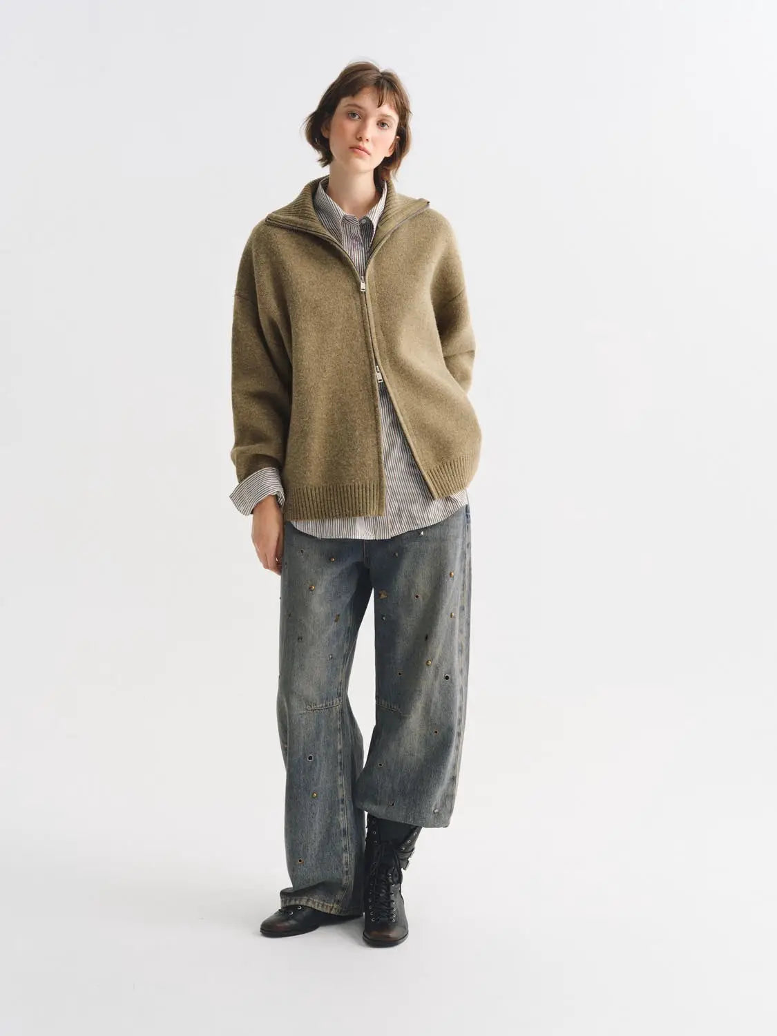 Knit jacket in camel beige with zip front, layered over a striped shirt