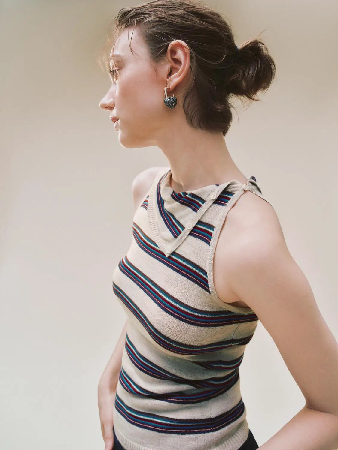 Striped knit tank top with an asymmetric neckline, beige base with teal and red stripes.
