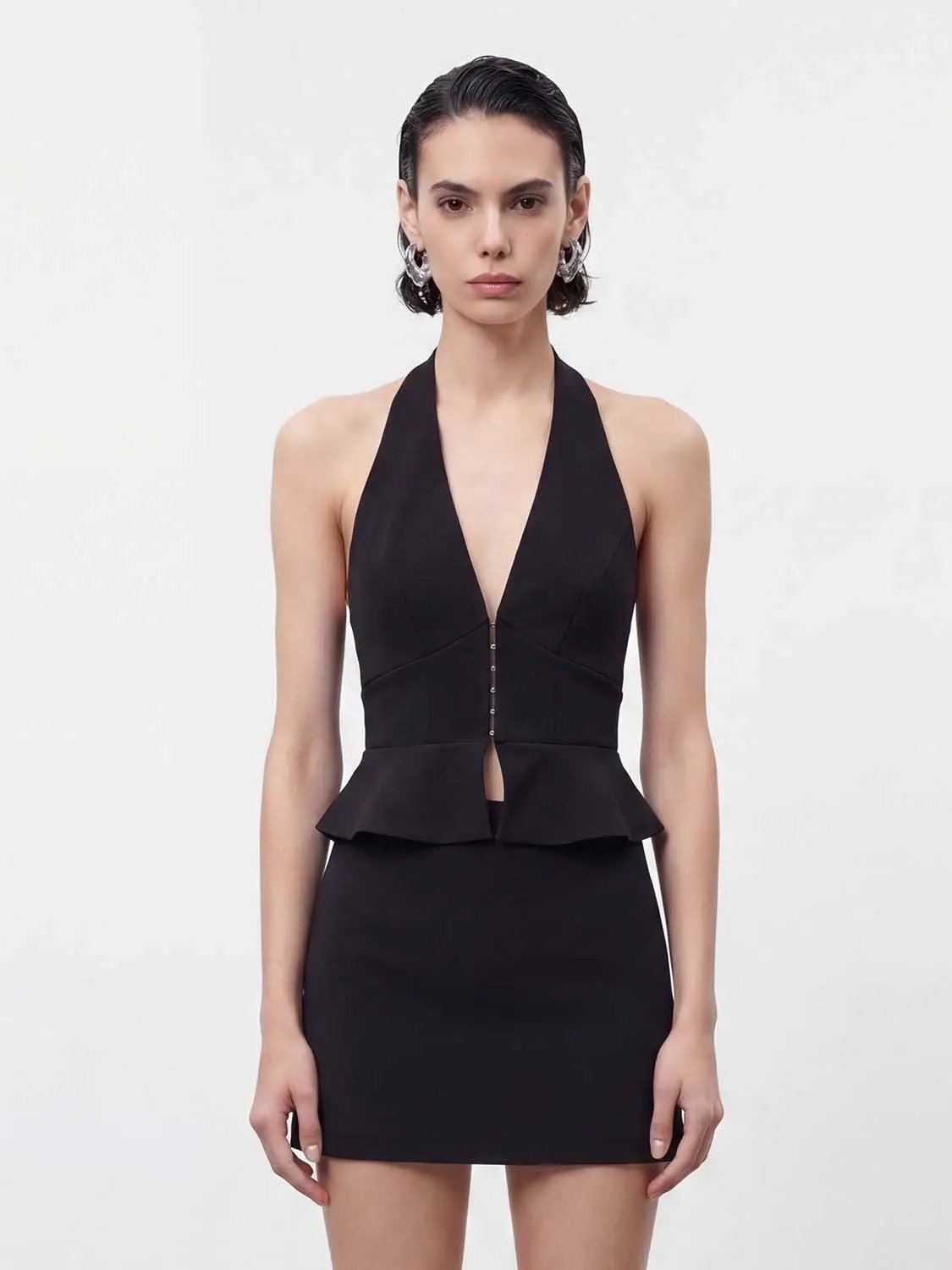 Shirt, black halter-neck top with plunging V, peplum waist, and center button closure.