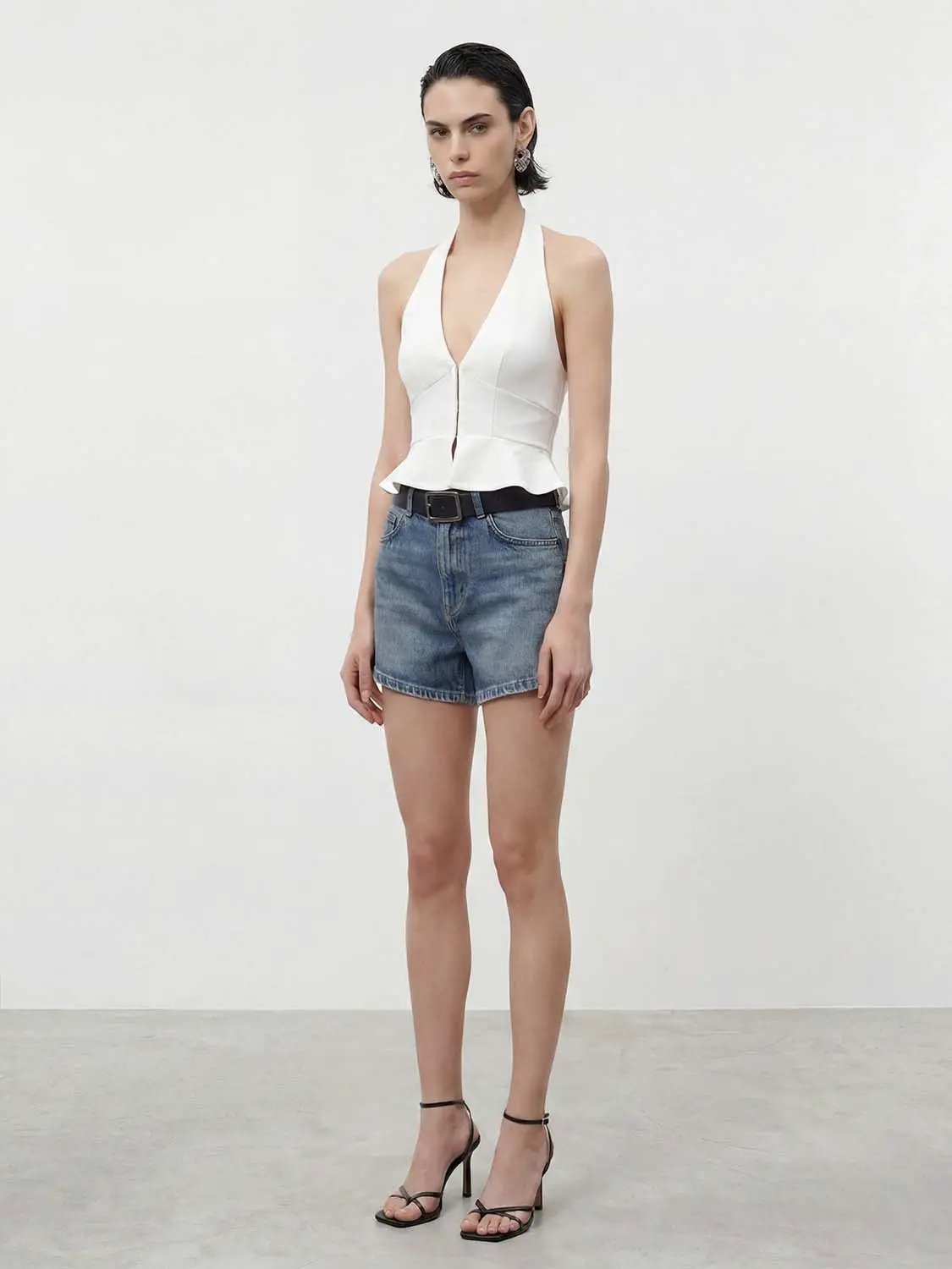Shirt, white halter-neck peplum top with deep V, paired with denim shorts