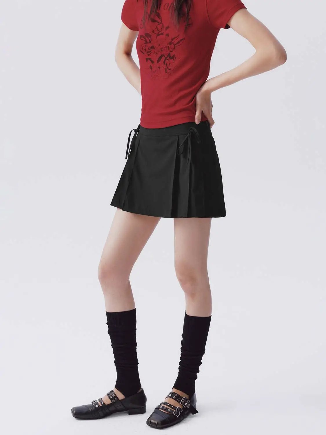 Stretch Skort in black with side ties and subtle pleats.