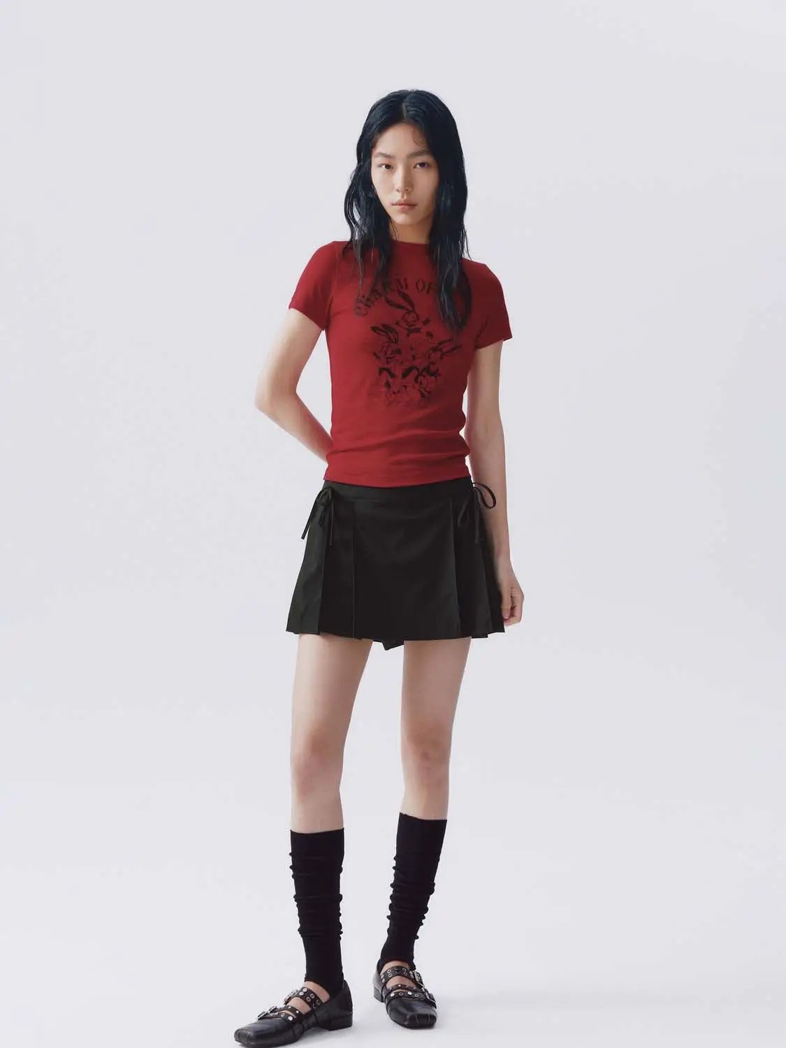 Stretch Skort; black pleated mini with side ties, worn with a red tee.