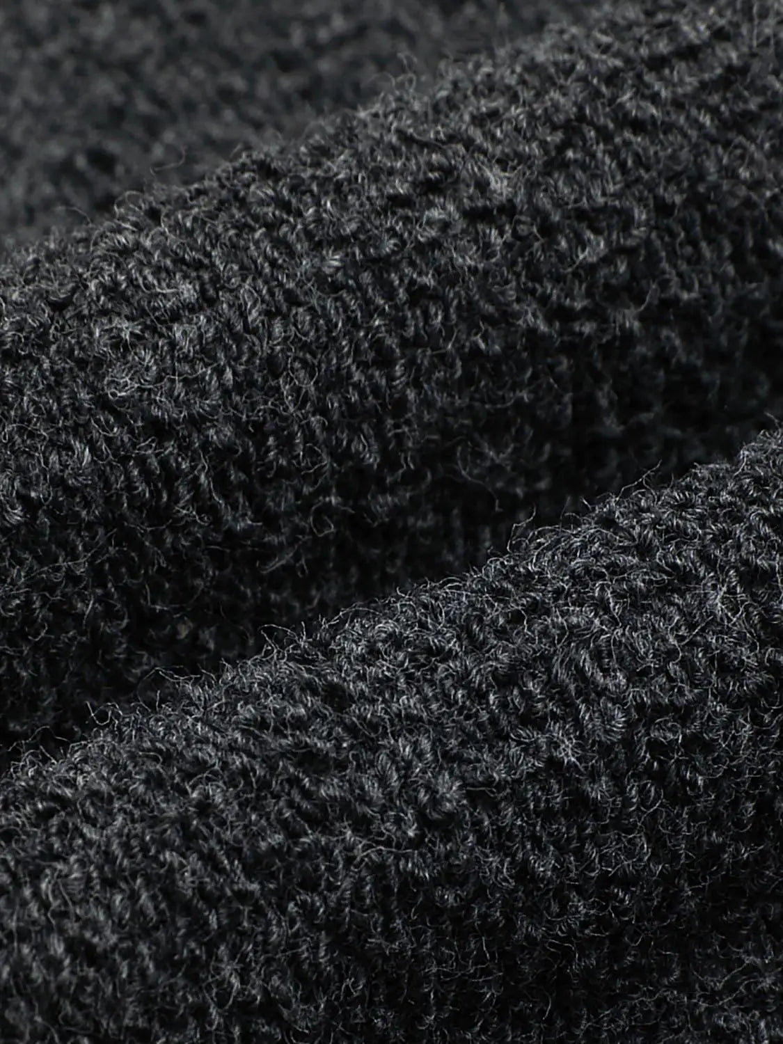 Jogger pants in black fleece-knit fabric; close-up shows soft, looped texture.