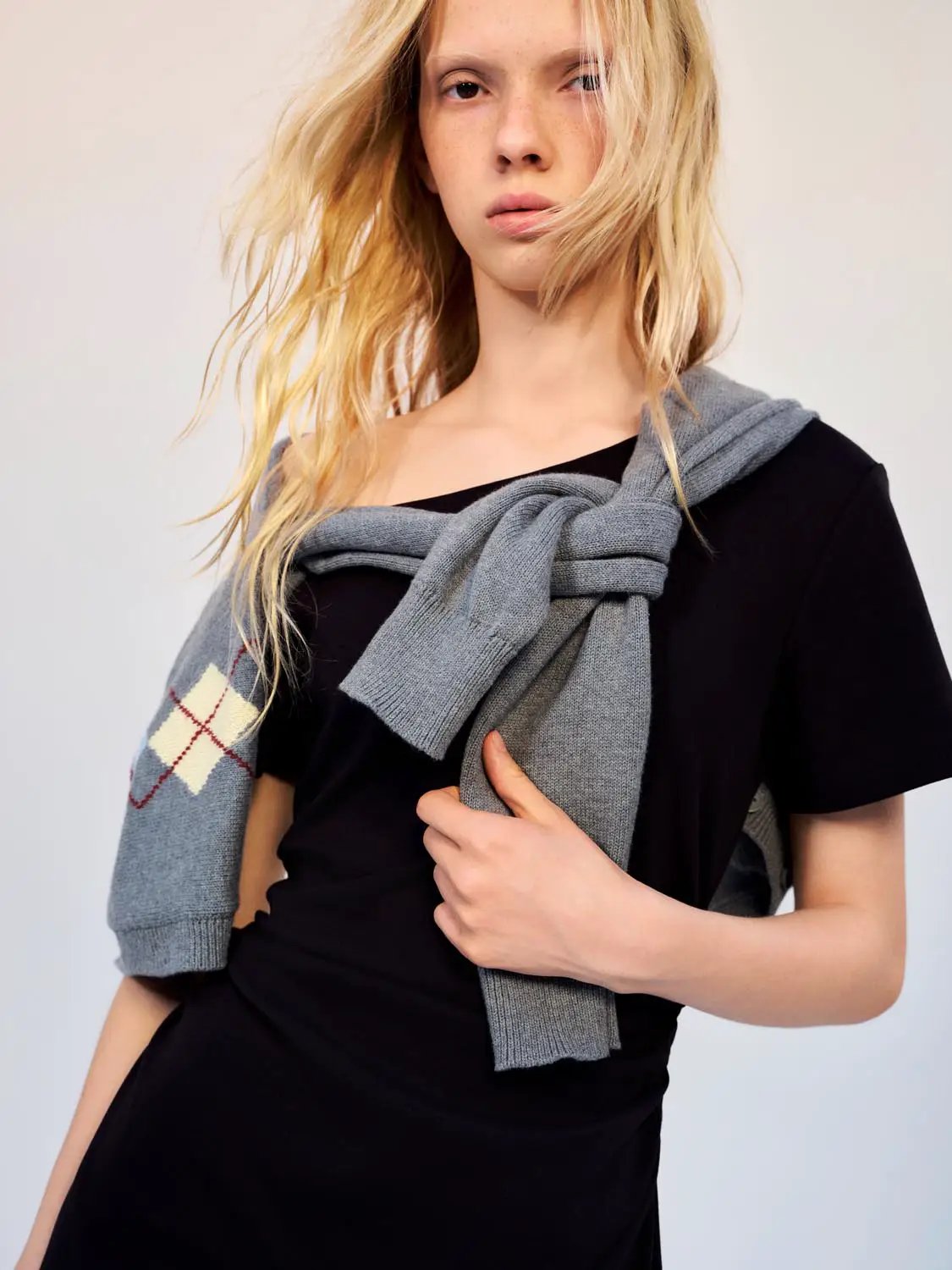 Cotton A-Line Dress in black with a gray knit cardigan draped over shoulders