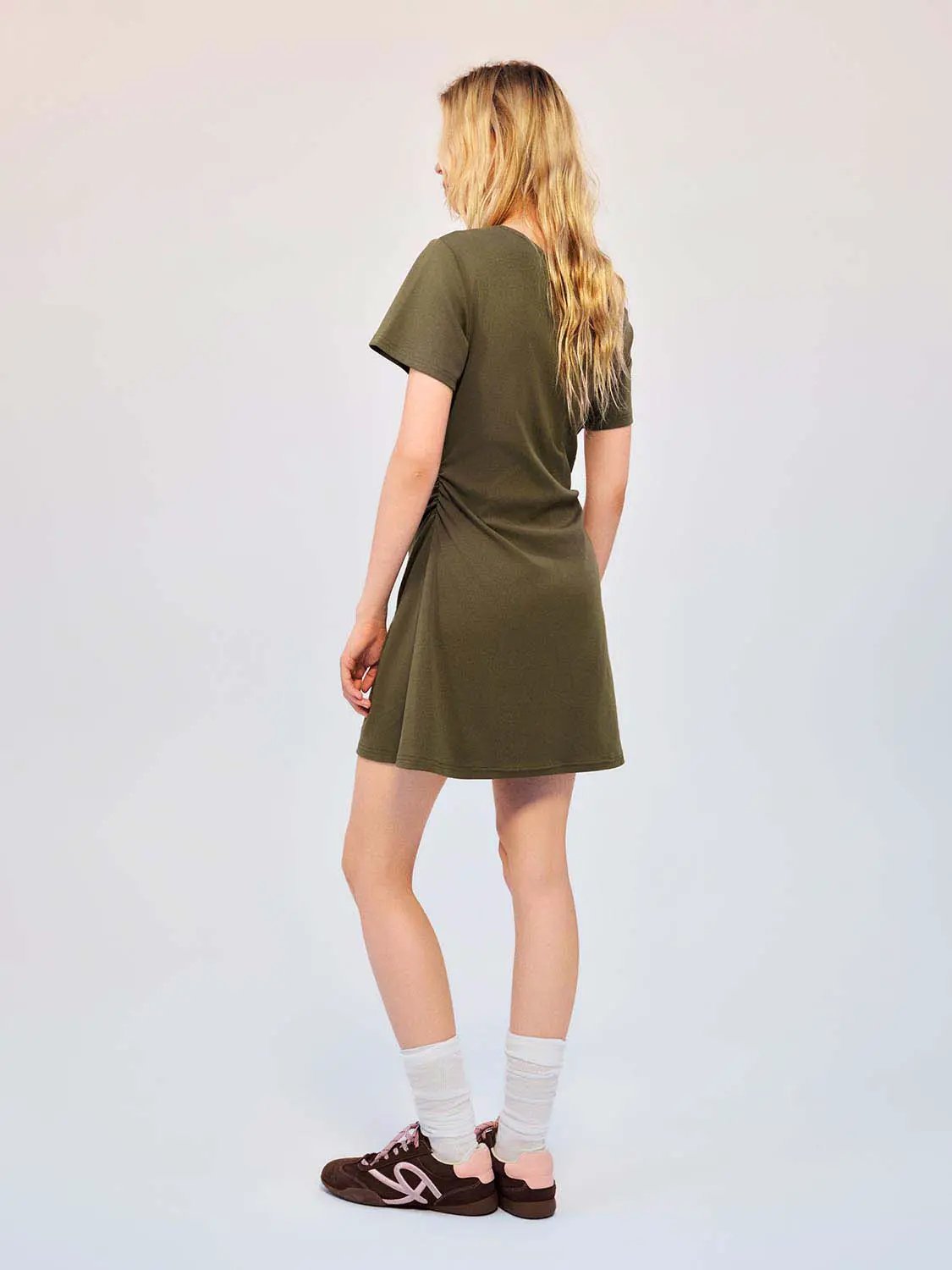 Cotton olive-green A-line dress, back view on model.