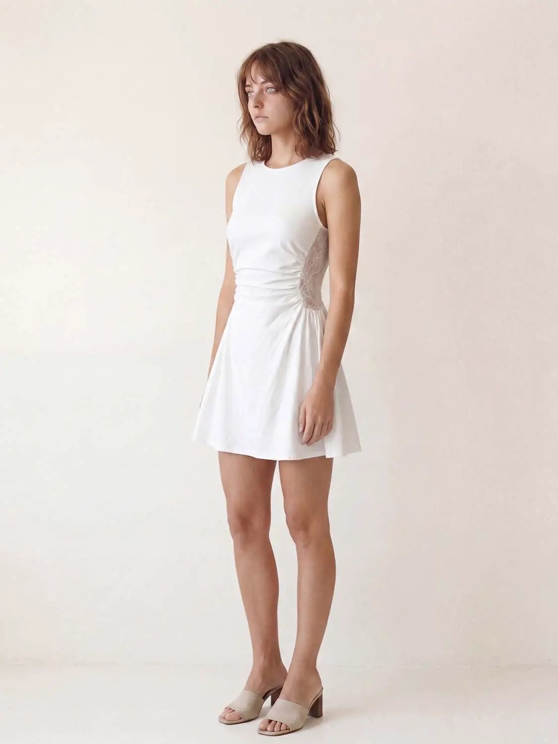 A-Line white dress on model, sleeveless, fitted waist with side ruching, hidden back zip, Urban Revivo Fashion.