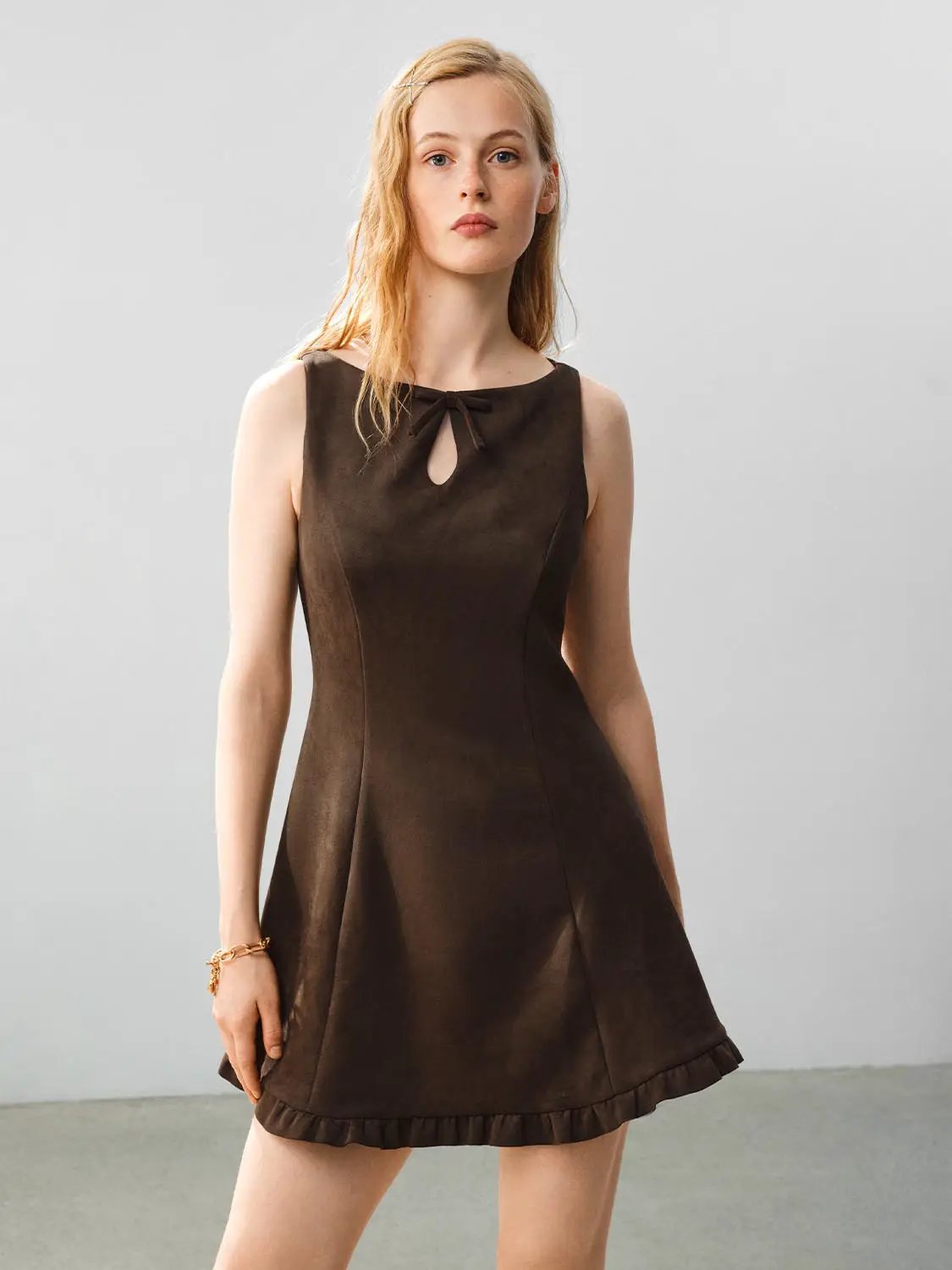 Ruffle Hem Bow Detail Sleeveless A-Line Mini Dress in brown with bow-neck tie, keyhole cutout, and ruffle hem.