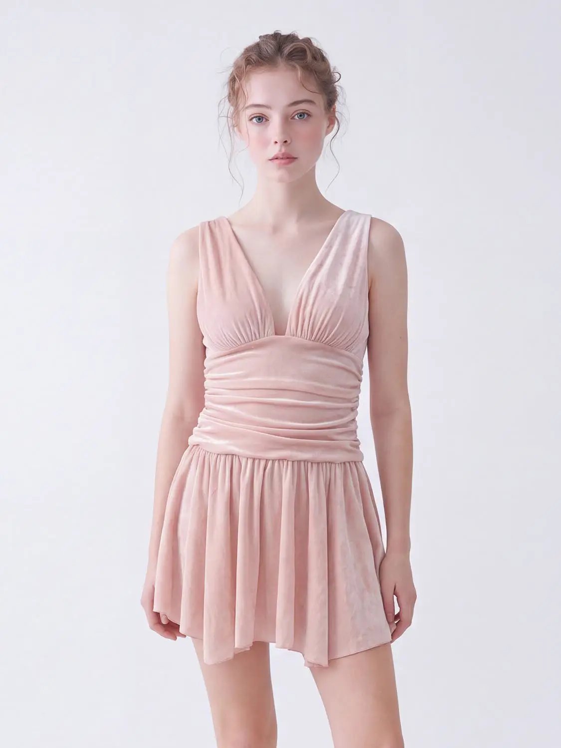 A-line dress in blush pink velvet with a plunging V-neck and ruched waist, short flowy skirt.