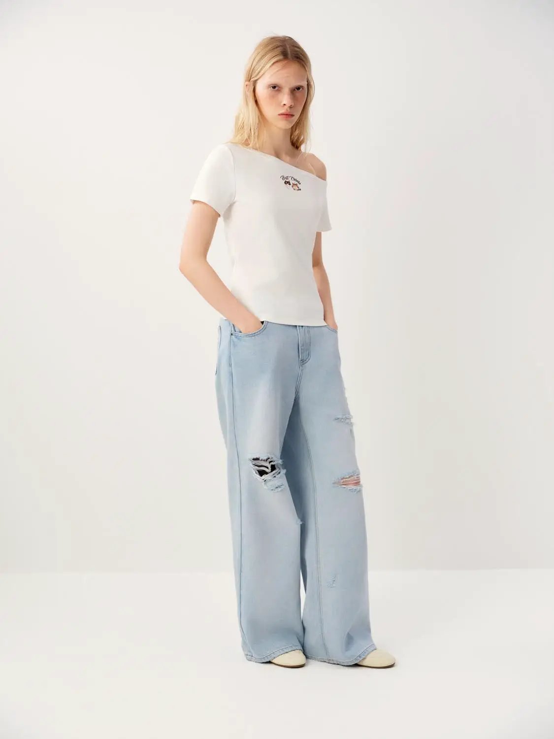 High-waisted distressed wide-leg cotton jeans in light blue denim with ripped knees