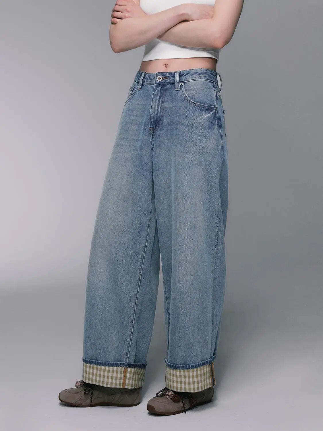 Light-wash wide-leg cotton-lyocell jeans by Urban Revivo Fashion; rolled cuffs reveal gingham lining.