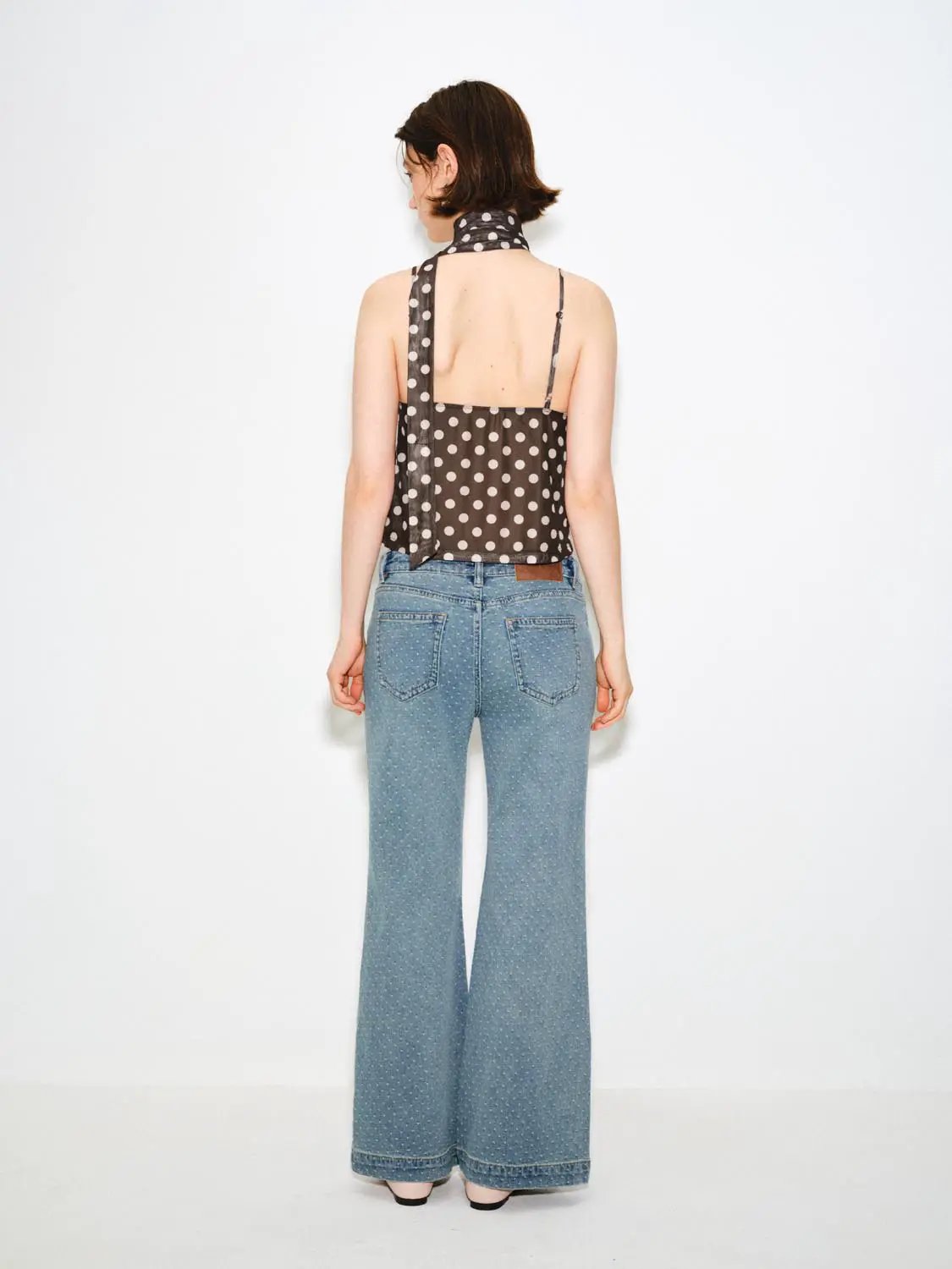 Wide-leg polka-dot cotton jeans, mid-rise with slight stretch; back view in light blue.