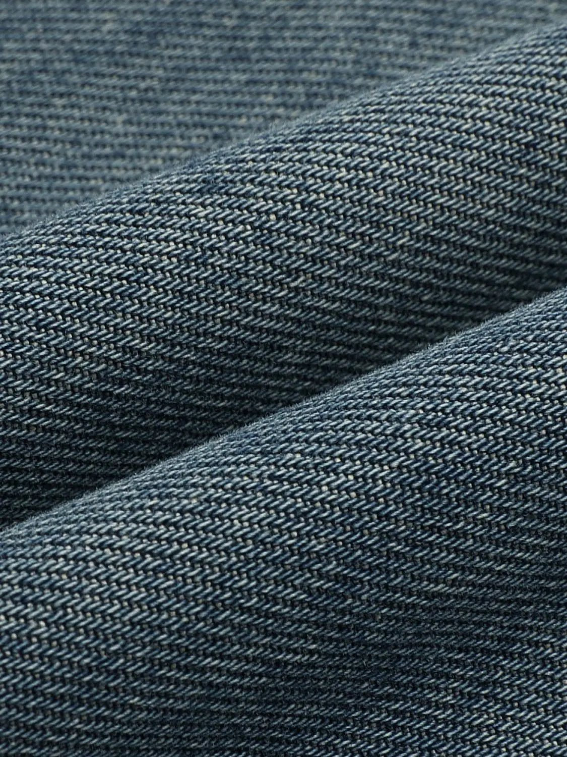 Jeans denim fabric close-up in blue indigo twill weave