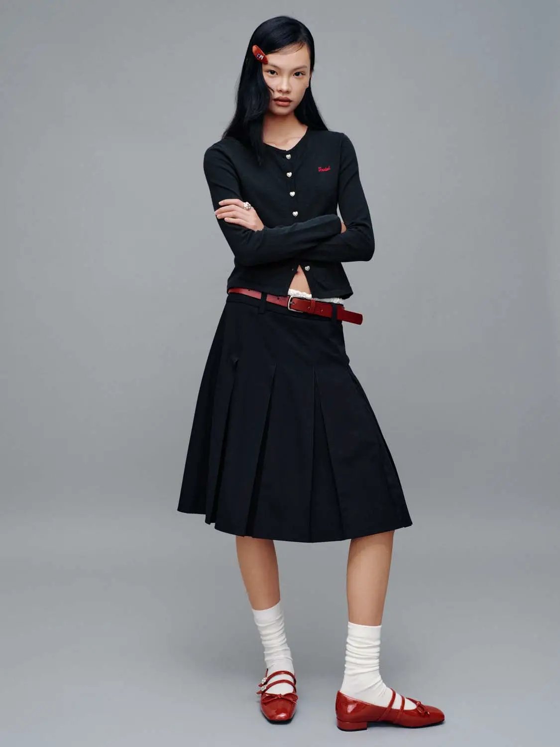 Crew neck knitted cardigan, black with red embroidery by Urban Revivo; two-piece outfit with a black pleated skirt