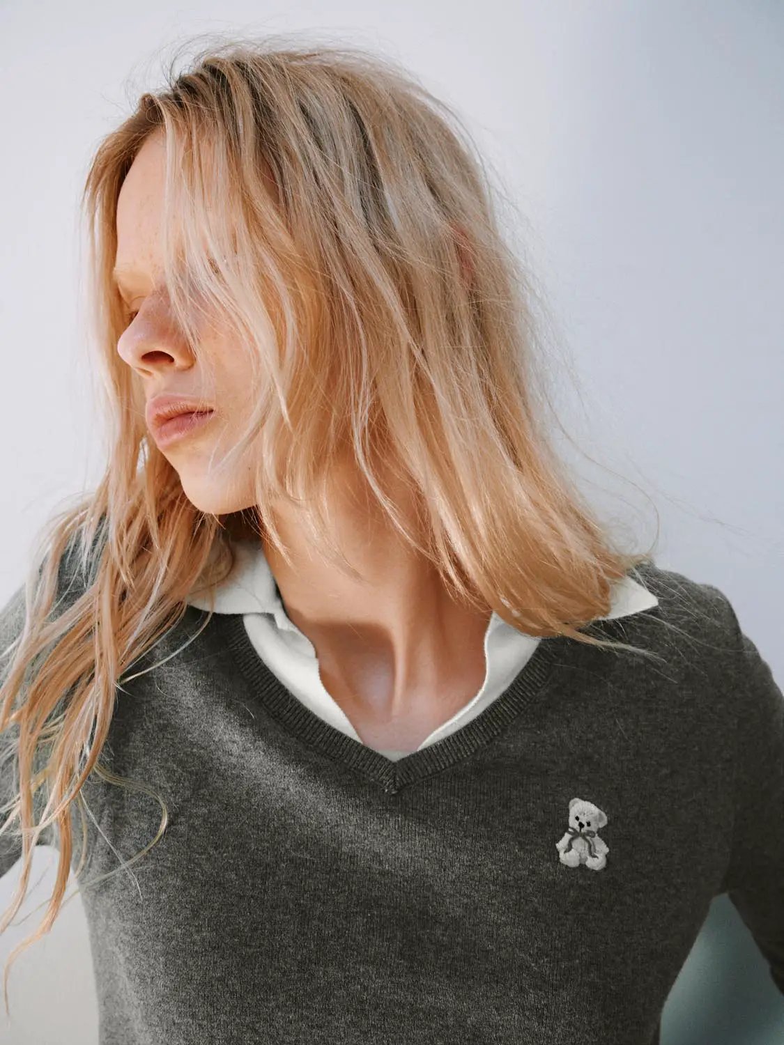 Knit T-Shirt by Urban Revivo Fashion in dark gray knit with a white collar layer and teddy bear logo.