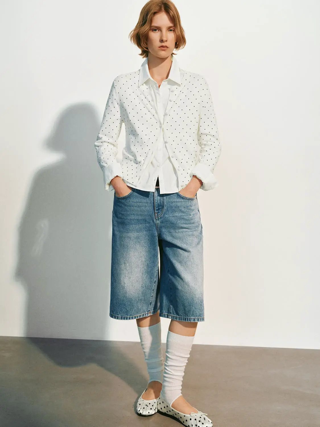 Knitted cardigan in white with small black polka dots.