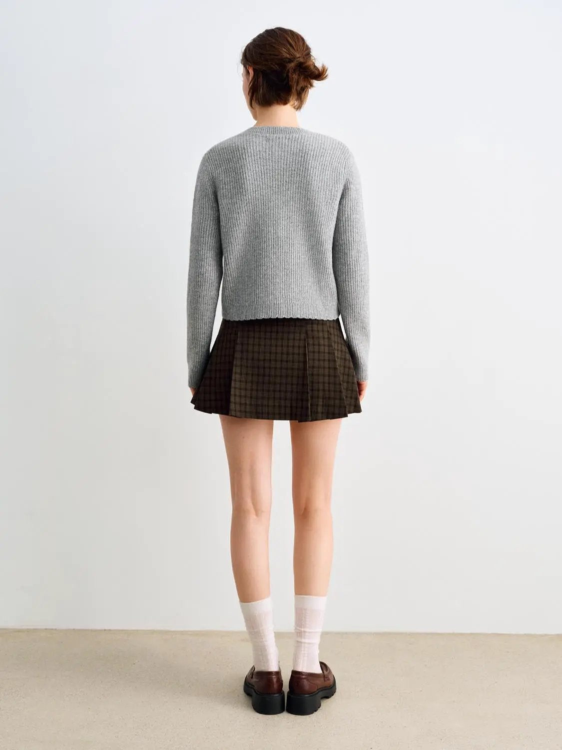 Knitted cardigan by Urban Revivo Fashion in gray, two-piece outfit with brown plaid skirt.