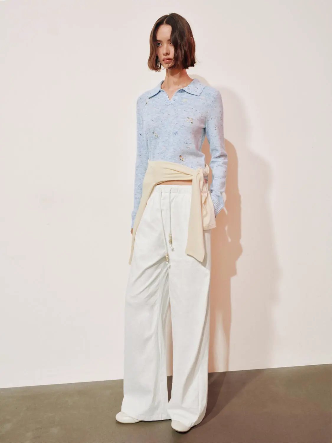Embroidered Floral Knit Polo Collar Long Sleeve Sweater in light blue; paired with white wide-leg pants