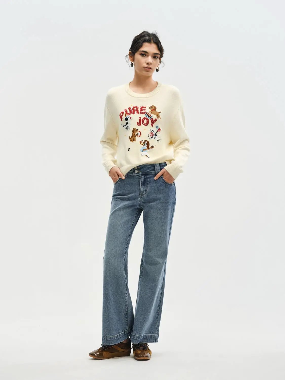 Knitted cream T-shirt with colorful animal graphic and PURE JOY text.