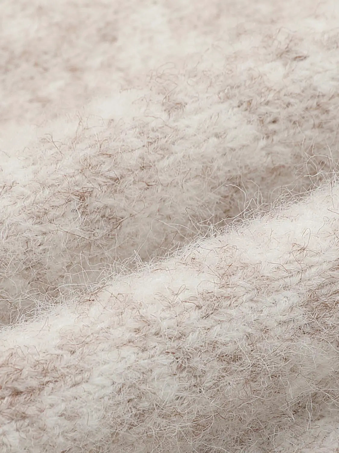 Knit T-Shirt fabric close-up in beige fuzzy knit texture