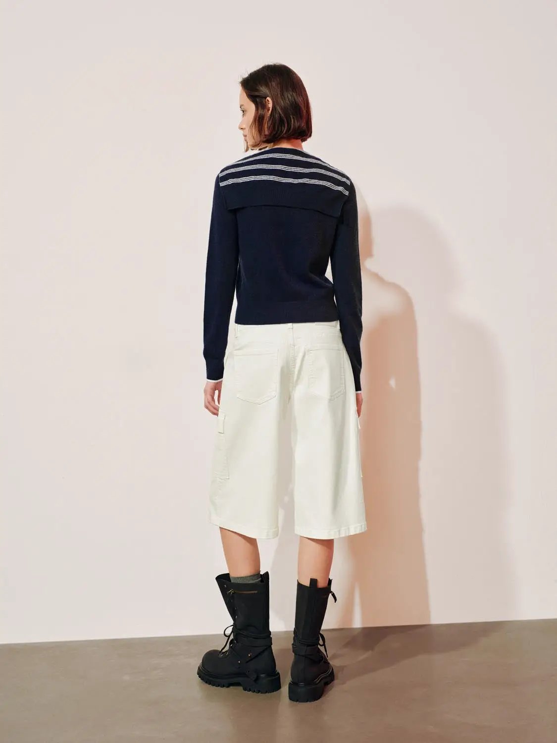Navy knit striped shawl-collar cardigan with button front, long sleeves, back view.