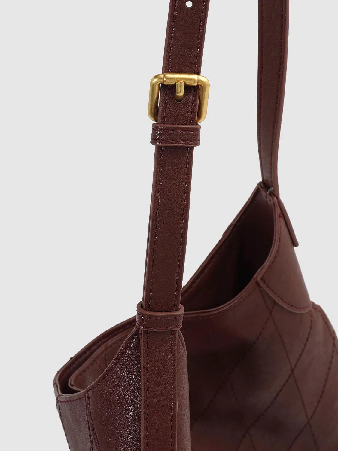 Shoulder bag in dark brown quilted leather with gold buckle strap detail