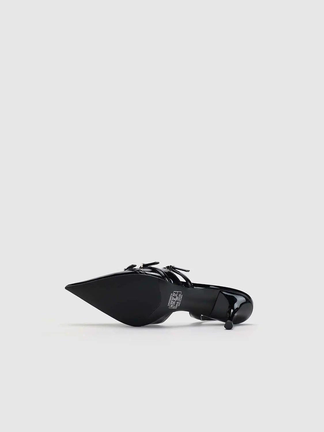 Slingback shoes in black patent with a pointed toe and ankle strap.