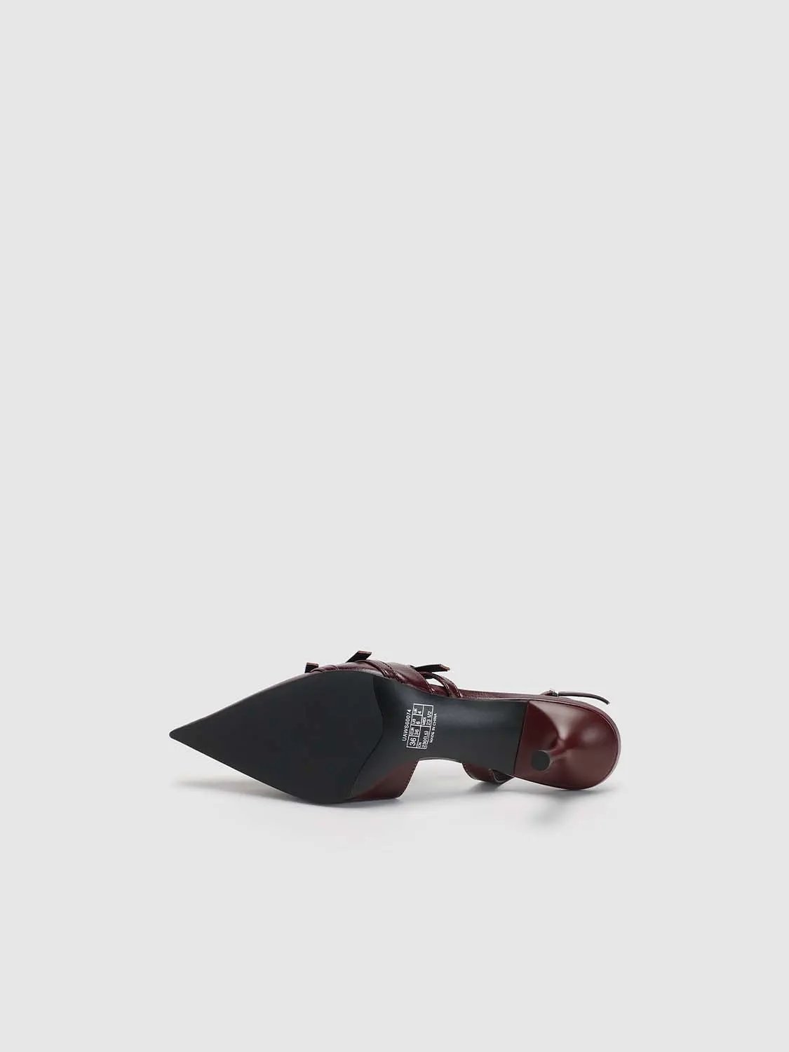 Slingback shoe in burgundy patent leather with a pointed toe and stiletto heel
