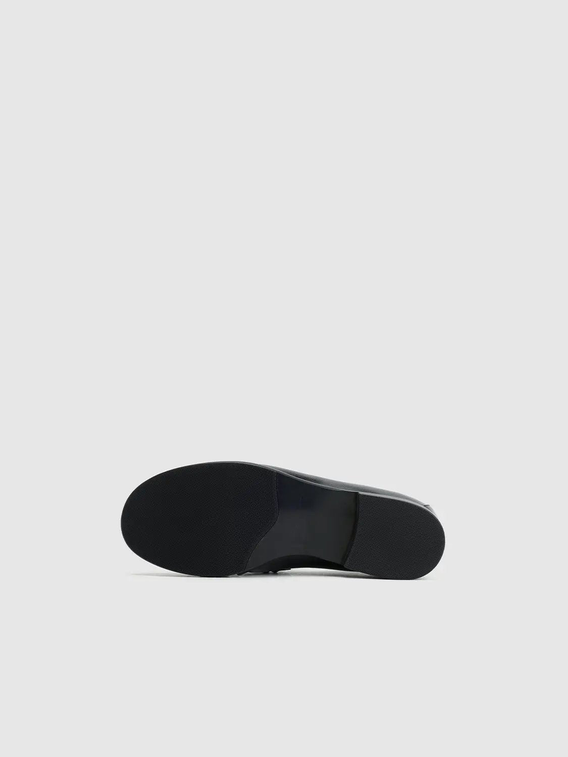 Pumps bottom sole view in black; close-up of outsole and heel on a flat dress shoe
