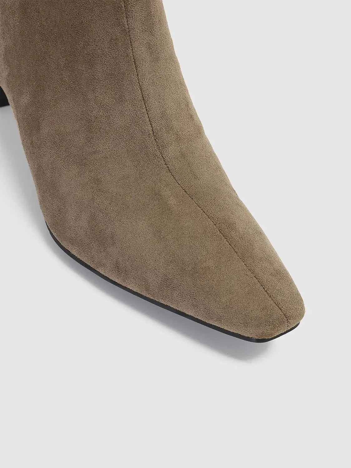 Taupe suede ankle boot with almond toe and visible seam detail
