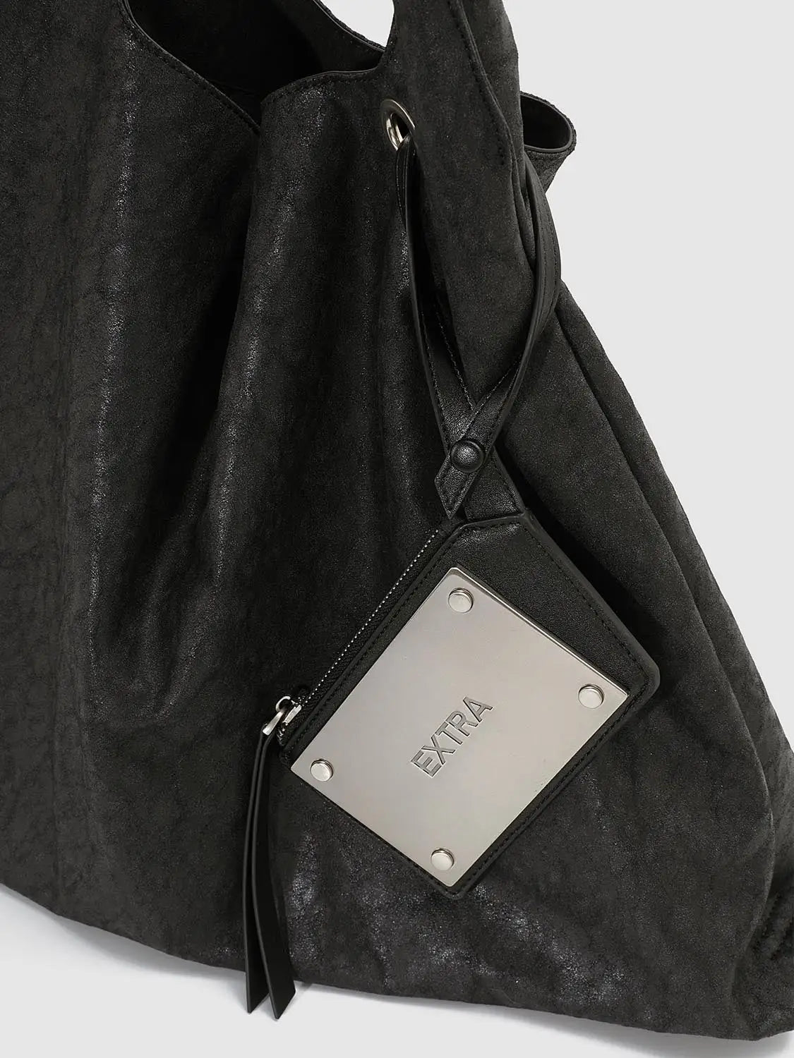 Shoulder bag in black suede with a square metal plate logo reading EXTRA.
