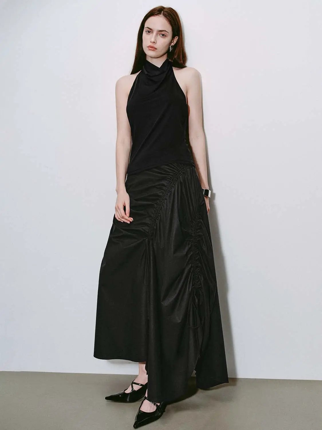 High-waisted ruched drawstring A-line cotton skirt in black with side slit and irregular hem