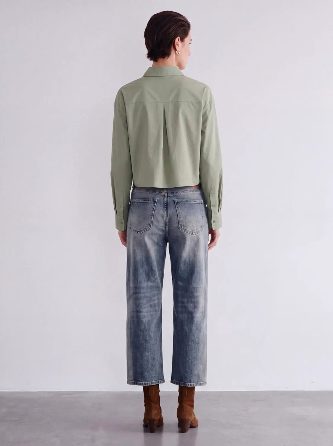 Cropped button-front non-stretch cotton shirt in olive green with a center-back pleat and long sleeves.