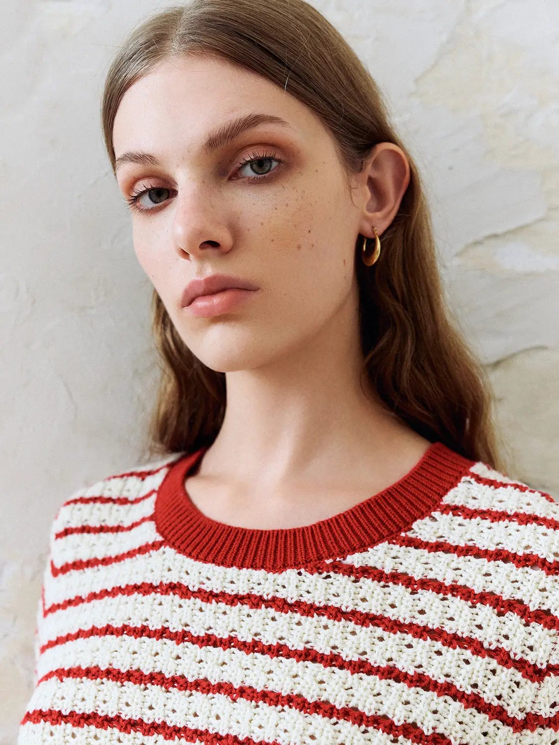 Cotton red-and-white striped textured knit T-shirt with red rib trim.