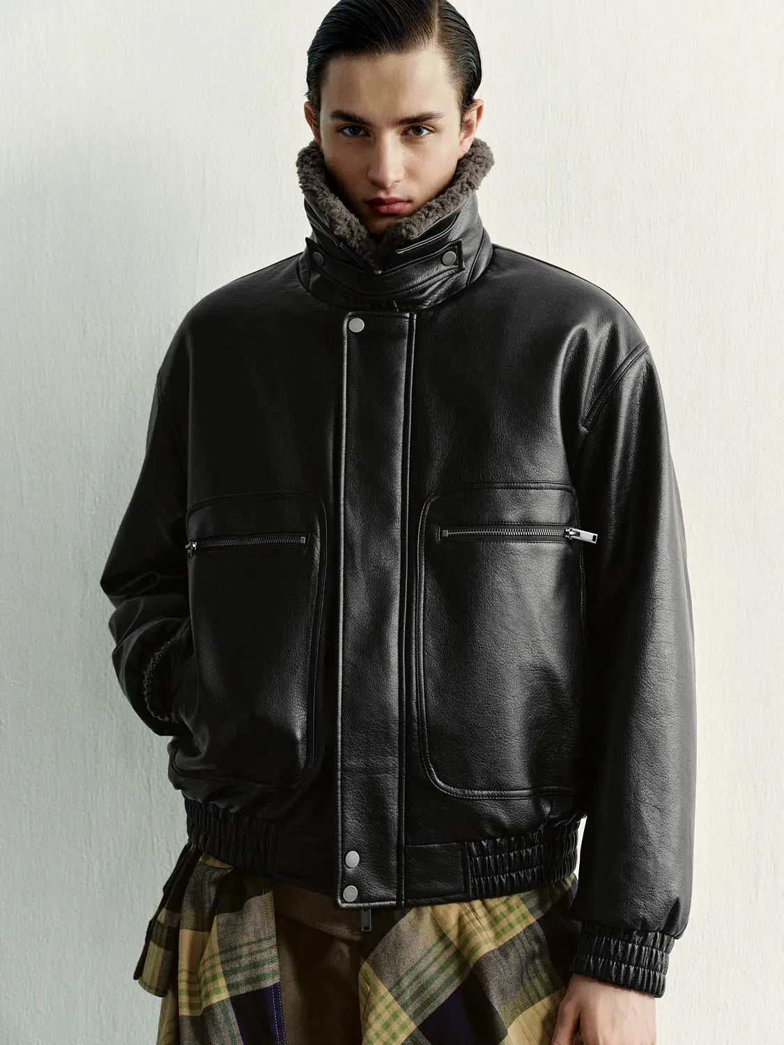Padded Jacket in black faux leather with shearling collar and zip pockets