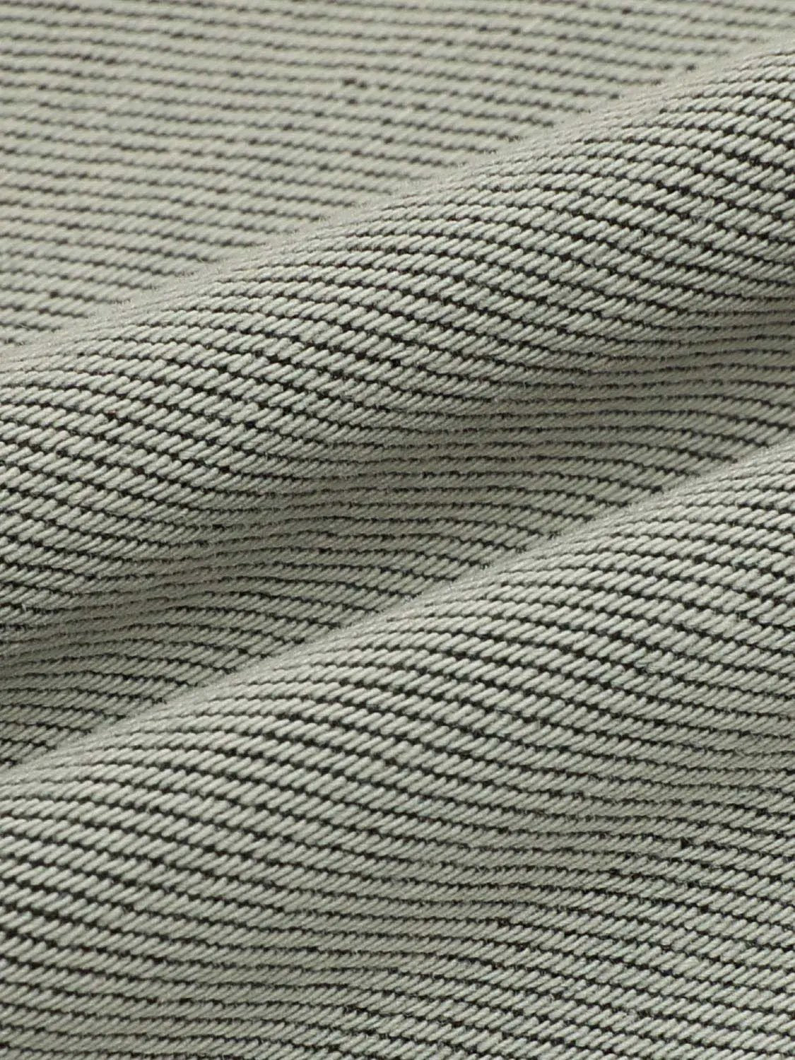 Jeans fabric close-up in light blue twill weave texture
