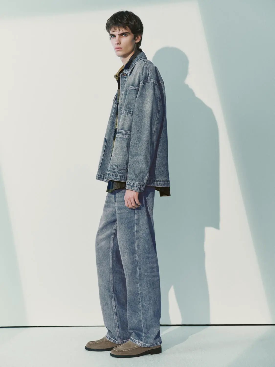 Denim jacket by Urban Revivo Fashion in blue denim; two-piece set with matching jeans worn by a male model