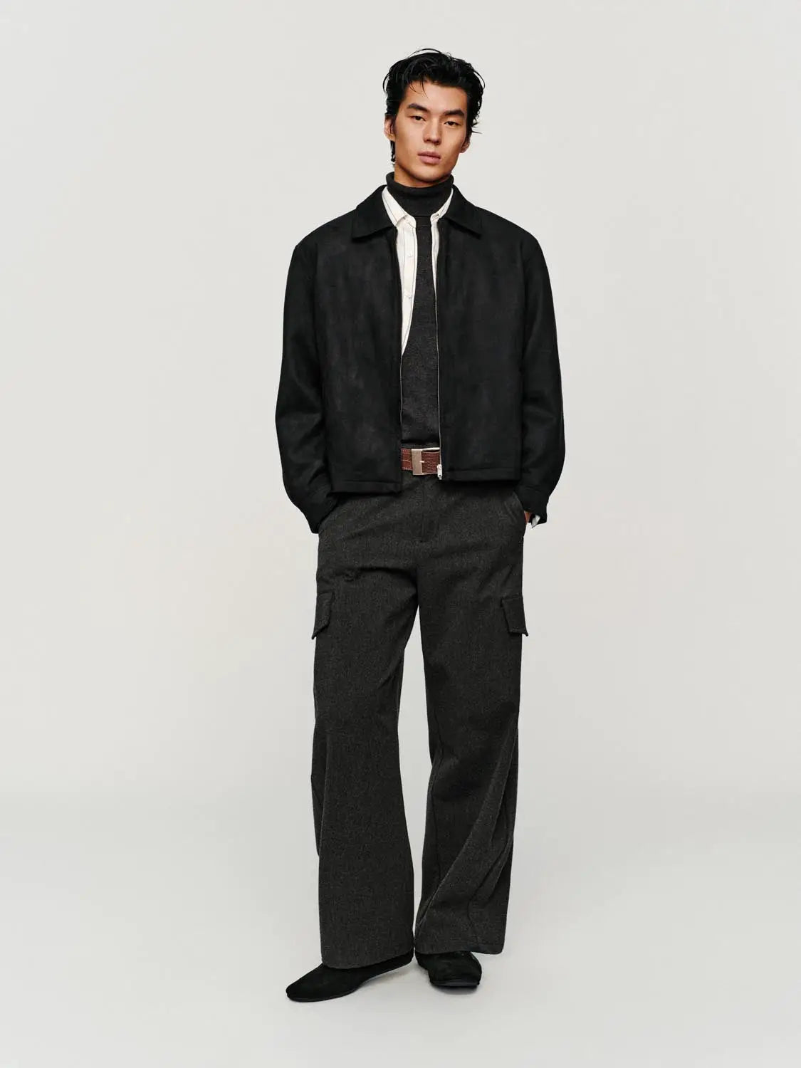 Jacket, black suede-style outerwear with zip-front; worn by a model in a black turtleneck and dark cargo pants