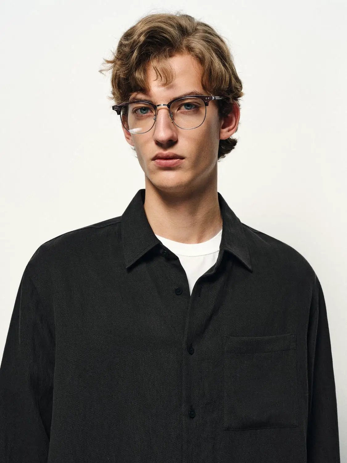 Cardigan shirt, black button-down with chest pocket worn by male model.