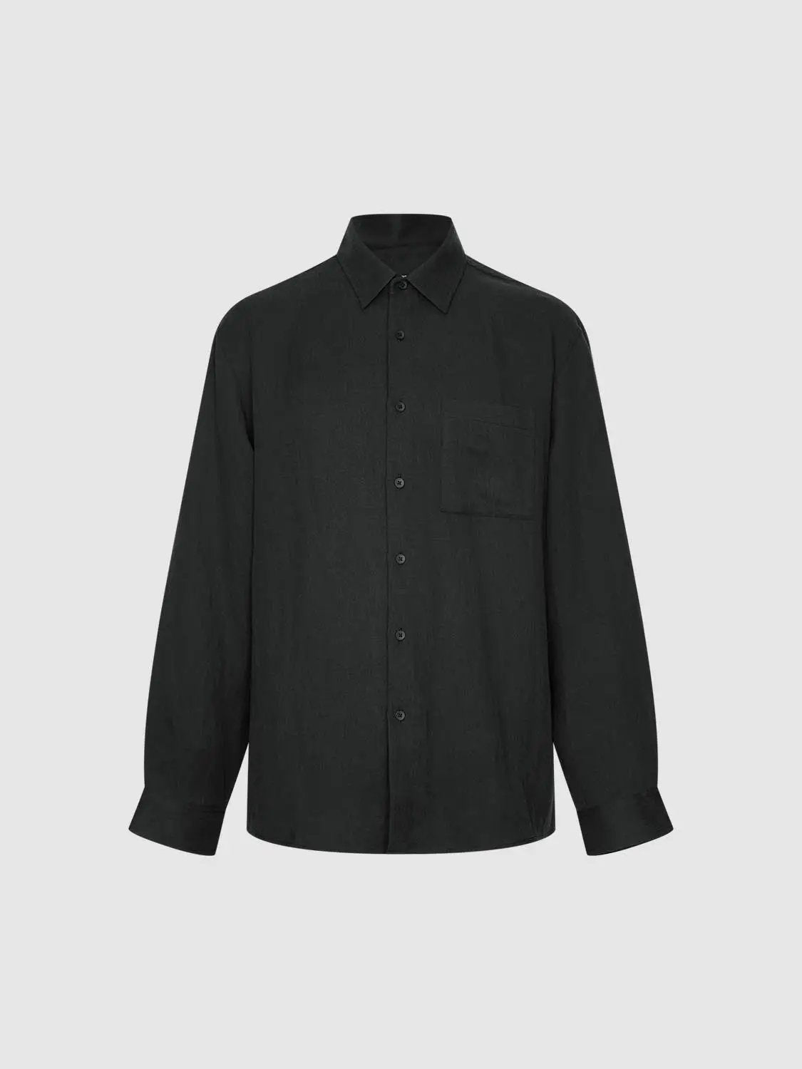 Cardigan shirt in black with front button-down and chest pocket.
