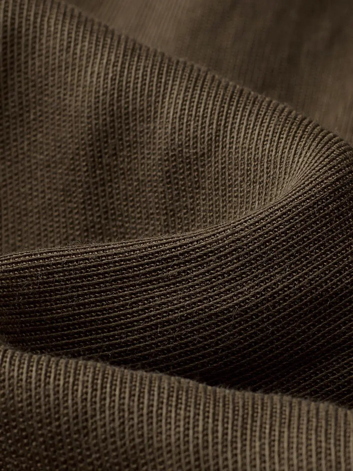 Cardigan shirt knit fabric close-up in dark brown with ribbed texture and curved seam by Urban Revivo Fashion